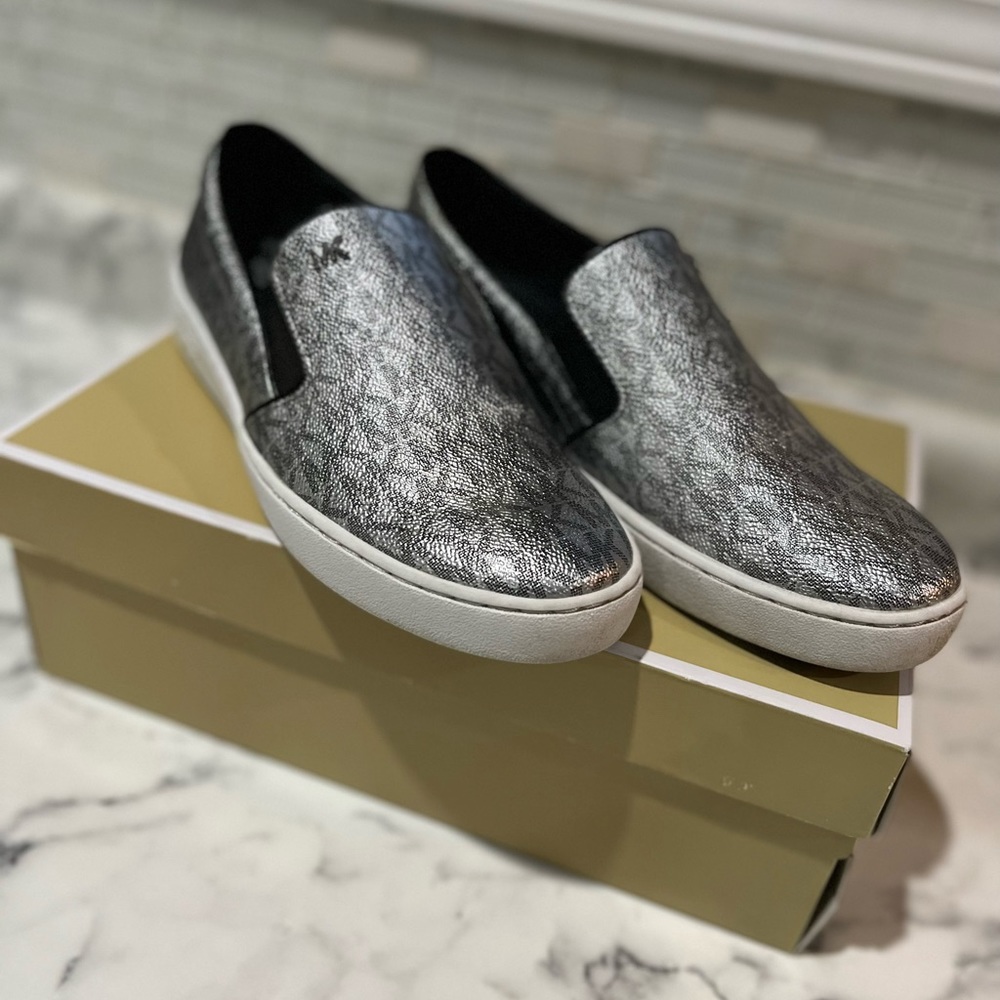 Michael Kors Size 8 slip on tennis shoe. Silver and gray.